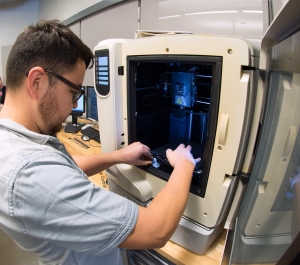 Student using a 3D printer