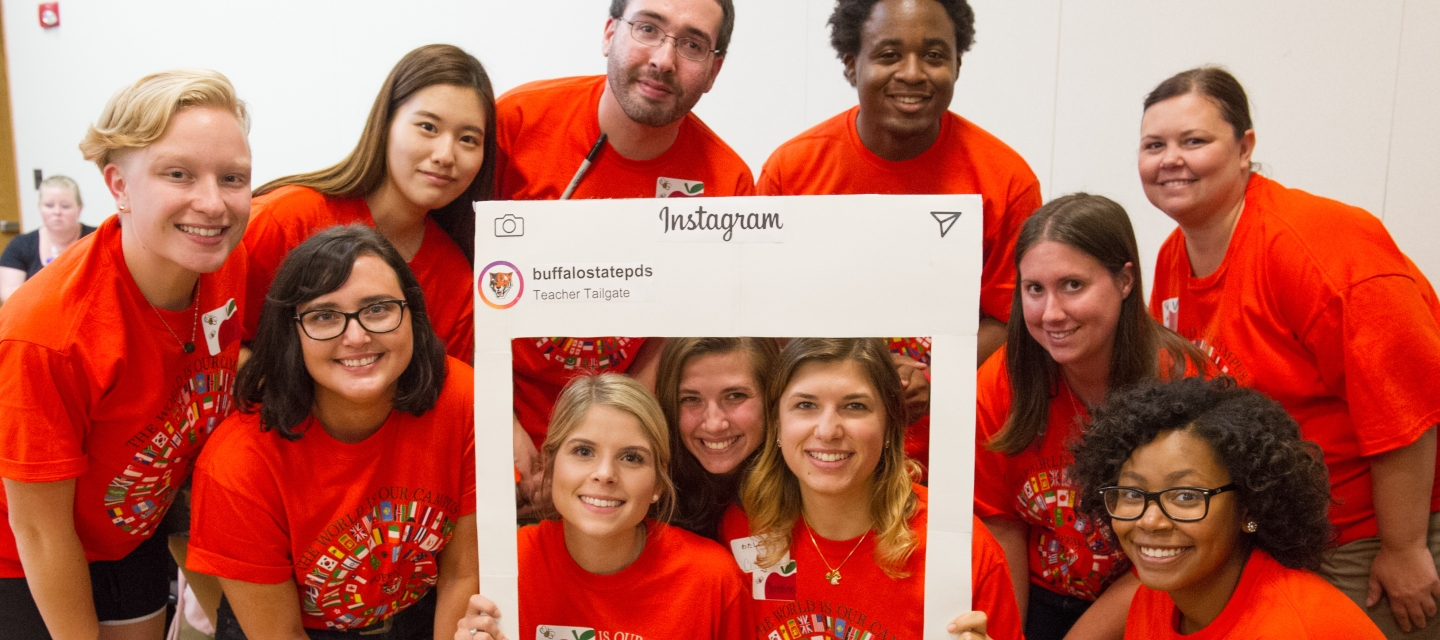 group of students in orange tshirts